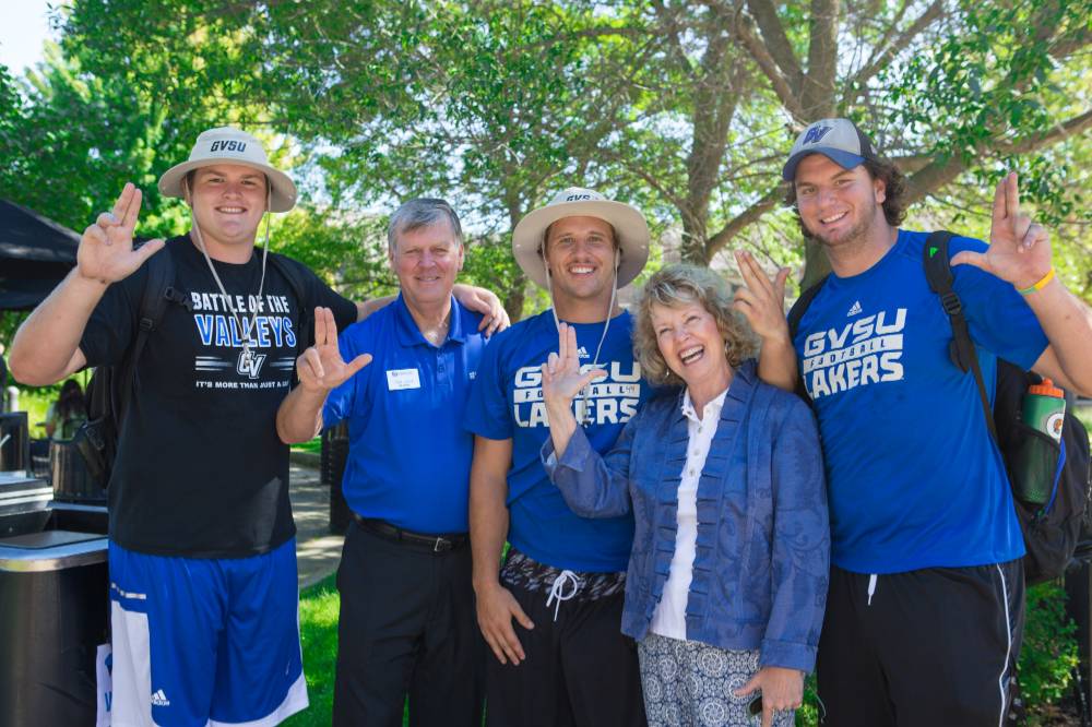 Former GVSU President Haas and his wife pose for a photo with Lakers during Move-In